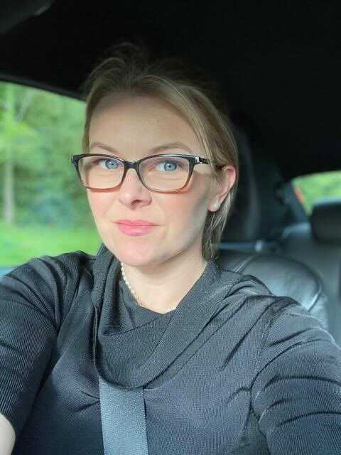 Jennie Parker in Car Wearing Black Sweater and Glasse