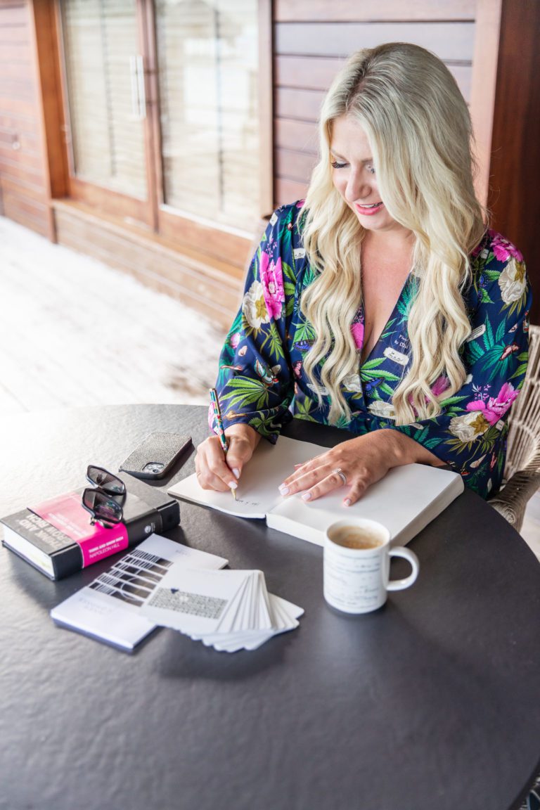 Emily writing her desires in a journal over morning coffee